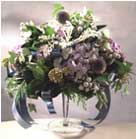 Purple Phlox, Echinops, Purple Pompons combined with special green accents in glass vase with leg