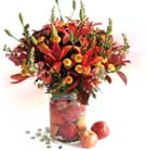 Lilies, Hypericum, Antirrhinum, Photinia and Yellow Pompons in glass vase